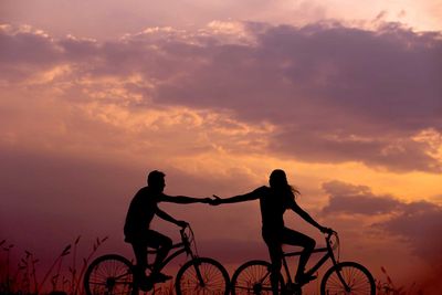 man and woman riding bikes
